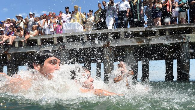 It was a close race to retrieve the cross thrown by Greek Orthodox Bishop Iakovos. Picture: Jason Sammon