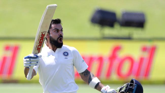 India's captain Virat Kohli raises his bat and helmet as he celebrates scoring a centuryin the second Test  South Africa at Centurion, South Africa. Picture: AFP/GIANLUIGI GUERCIA