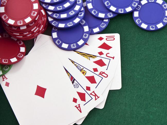 Royal flush & gambling chip. Thinkstock photo