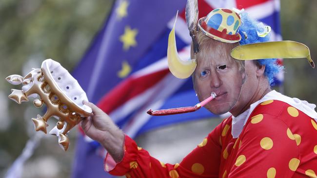 An anti Brexit demonstrator wears a mask depicting Britain's prime minister Boris Johnson protests outside the Cabinet office in London, Thursday, Aug. 29, 2019. Political opposition to Prime Minister Boris Johnson's move to suspend Parliament is crystalizing, with protests around Britain and a petition to block the move gaining more than 1 million signatures. (AP Photo/Alastair Grant)