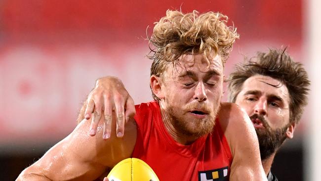 Hugh Greenwood (left) of the Suns is tackled by Justin Westhoff (right) of the Power during the Round 1 AFL match between the Gold Coast Suns and Port Adelaide Power at Metricon Stadium on the Gold Coast, Saturday, March 21, 2020. (AAP Image/Darren England) NO ARCHIVING, EDITORIAL USE ONLY