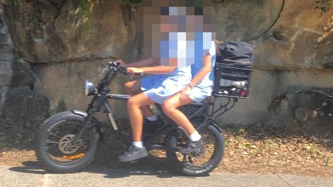 Secondary schools students, without helmets on an e-bike at Freshwater. Picture: Jim O'Rourke