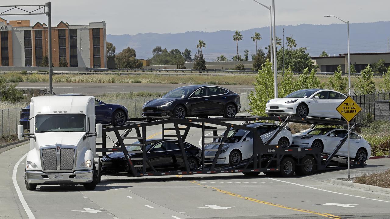 A truck hauling new Tesla vehicles leaves the plant in Fremont. Picture: Ben Margot/AP