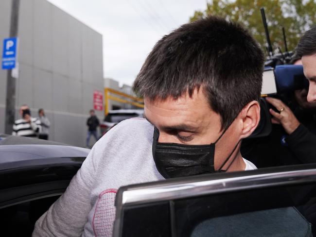 Richard Pusey, the driver of a Porsche who allegedly fled the scene of a truck crash on Melbourne's Eastern Freeway which killed four police officers, is taken away from his Fitzroy property by police in Melbourne, Thursday, April 23, 2020. (AAP Image/Michael Dodge) NO ARCHIVING