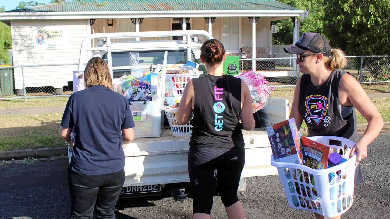 CHRISTMAS SPIRIT: Irene Tanks, Hamey Hayllor and Cass Schultz unloading the hampers put together by Physical Fix members. Picture: Shannon Hardy