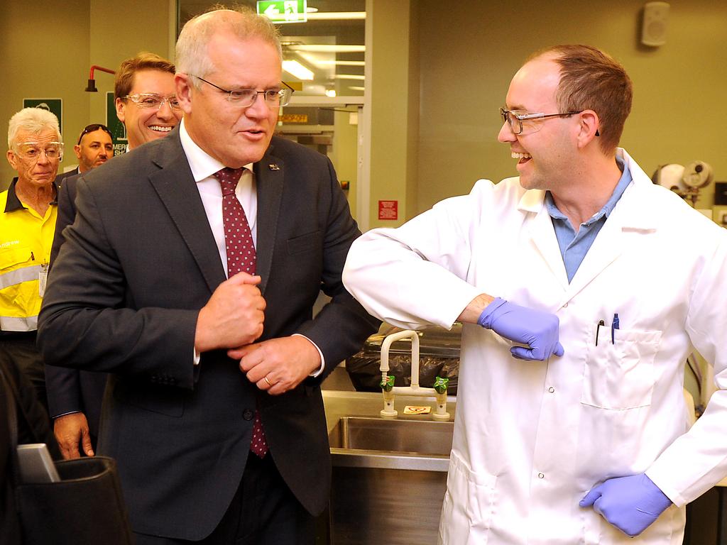 Scott Morrison bumps elbows while visiting a business in Brisbane. Picture: NCA NewsWire / John Gass