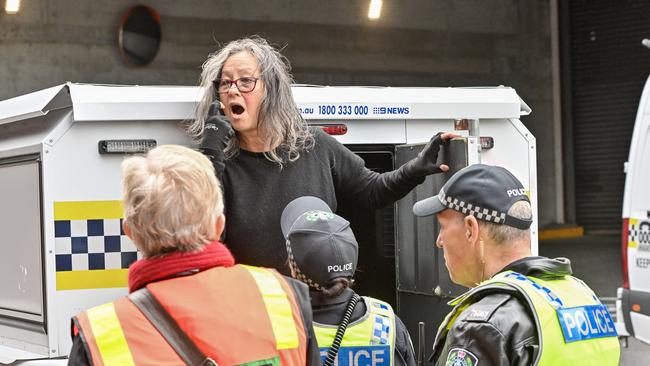 Extinction rebellion protester Meme Thorne is arrested after disrupting Adelaide traffic by abseiling from the Morphett Street Bridge. Picture: NCA NewsWire / Brenton Edwards