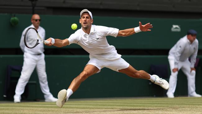 Novak Djokovic stretches to play a forehand against Nick Kyrgios. Picture: Getty Images