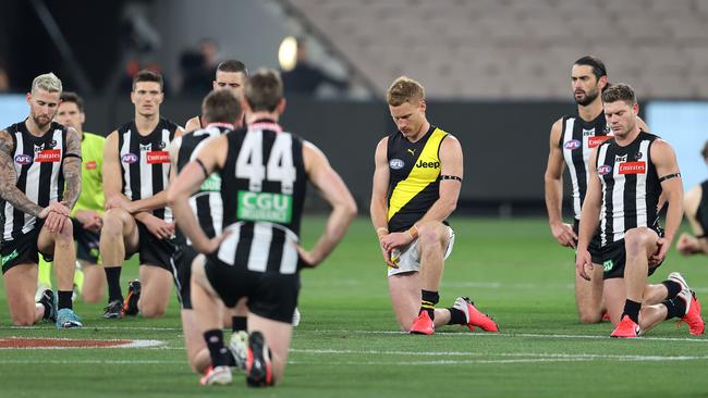 Collingwood and Richmond players take a knee to show support for the Black Lives Matter movement. Picture: Michael Klein