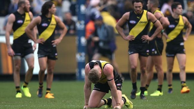 A shattered Josh Caddy on his knees after the siren. Picture: Wayne Ludbey