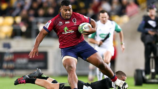 Taniela Tupou of the Reds beats the tackle of TJ Perenara of the Hurricanes.