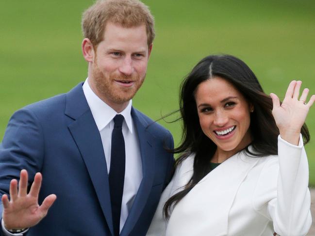 (FILES) This file photo taken on November 27, 2017 shows Britain's Prince Harry and his fiancée US actress Meghan Markle posing for a photograph in the Sunken Garden at Kensington Palace in west London following the announcement of their engagement. Meghan Markle is to become the first fiancee invited to spend Christmas with the British royal family -- a move hailed December 14, 2017, as a sea change in the monarchy's traditionalist attitude. / AFP PHOTO / Daniel LEAL-OLIVAS