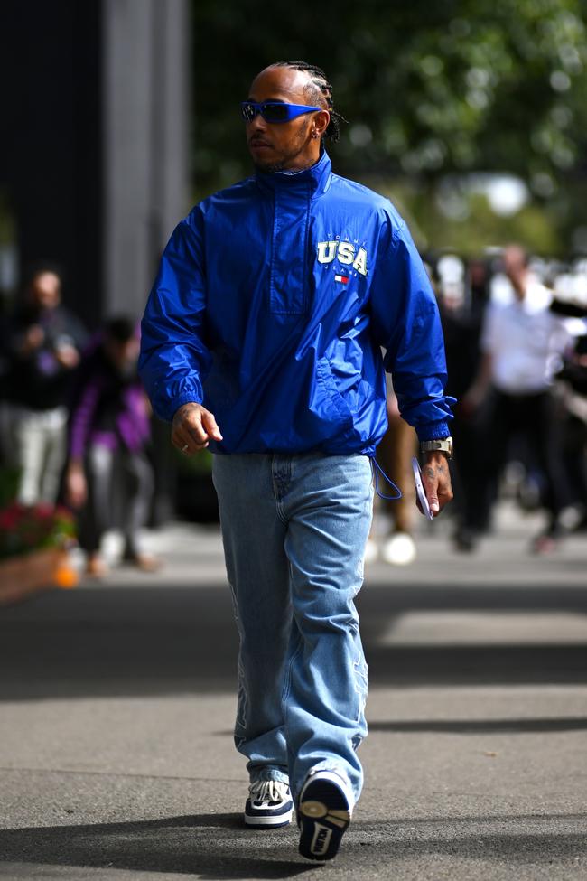 Lewis Hamilton wears a Tommy Jeans jacket and denim, Louis Vuitton trainers, and Vuarnet sunglasses at the Australian GP.