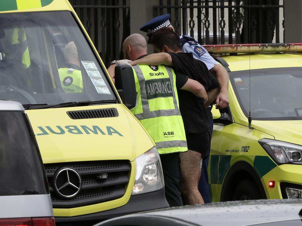 Police and ambulance staff help a wounded man from outside a mosque in central Christchurch, New Zealand, Friday, March 15, 2019. (AP Photo/Mark Baker)