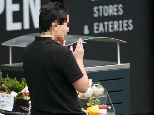 Somebody smokes outside the Beecroft Place shopping centre. Picture: Tim Pascoe