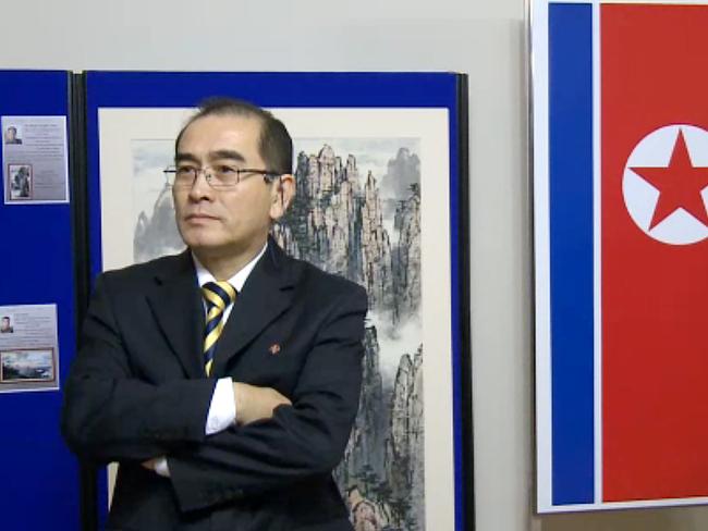 In a video grab created on August 17, 2016 taken from footage recorded by AFPTV on November 3, 2014 deputy ambassador at the North Korean embassy in London, Thae Yong-ho, stands in front of an artwork during a photocall to view an exhibition of North Korean art at the North Korean embassy in west London. South Korea said on August 17, 2016 that North Korea's deputy ambassador to Britain Thae Yong-Ho had defected to Seoul, in a rare and major loss of diplomatic face for Pyongyang. / AFP PHOTO / AFPTV / KATIE SCHUBAUBR