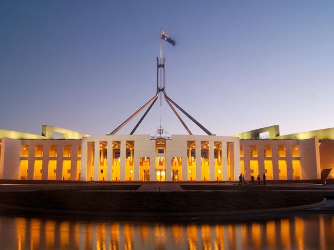 Parliament House in Canberra, Australia, illuminated at dusk.