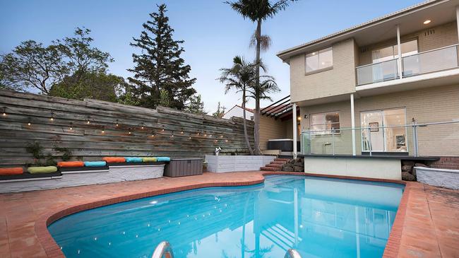 The large in-ground pool has a deck next to it.