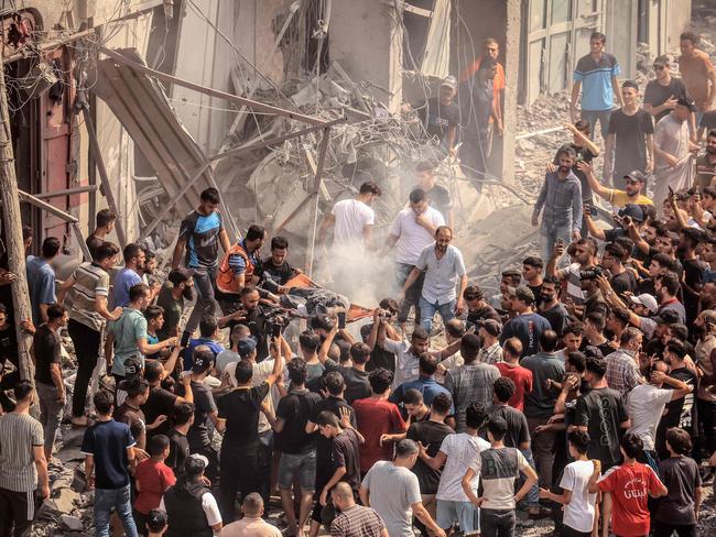 Palestinians evacuate a body following an Israeli air strike on the Sousi mosque. Picture: Mahmud Hams/AFP