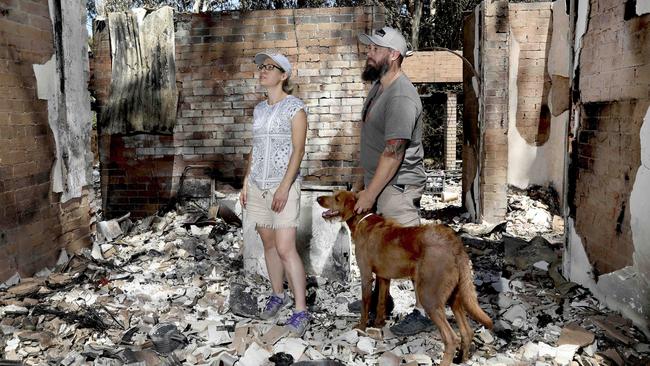 Marc and Rhiann Webb, with their dog Rory, return to their burnt home after the fires. Picture: Dean Martin / AAP