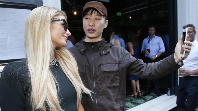 Paris Hilton taking a selfie with a fan after arriving at the Garden State Hotel, Melbourne. Picture: David Caird.