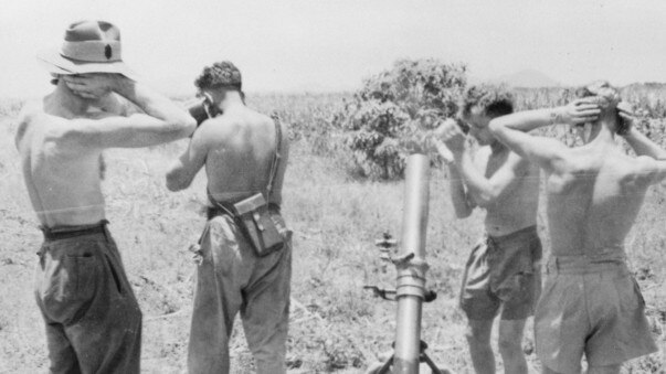 Members of the 1st Field Trials Company cover their ears as a 4.2 inch mortar fires a gas canister during an experiment on the effects of mustard gas and other chemical warfare agents. Credit: Australian War Memorial