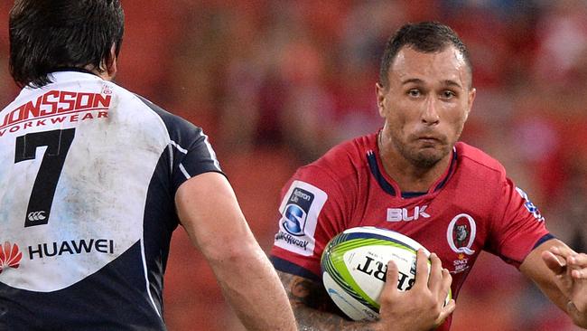 BRISBANE, AUSTRALIA - MARCH 27: Quade Cooper of the Reds looks to take on the defence during the round seven Super Rugby match between the Reds and the Lions at Suncorp Stadium on March 27, 2015 in Brisbane, Australia. (Photo by Bradley Kanaris/Getty Images)