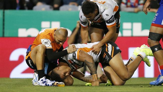 Michael Chee-Kam receives attention after suffering a head knock in a match against the Knights in 2019. Picture: AAP