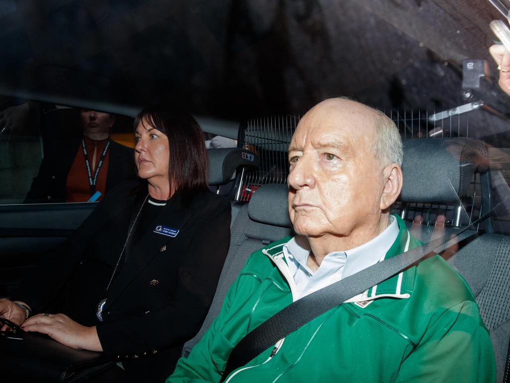 <p>TV and radio host Alan Jones arrives with detectives at Day Street Police Station after his arrest in Sydney in November. Picture: Max Mason-Hubers</p>