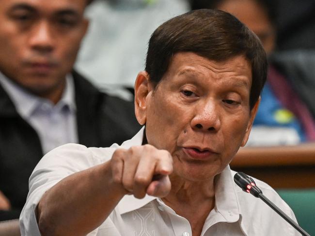 (FILES) Former Philippine president Rodrigo Duterte gestures as he attends a senate probe on the drug war during his administration, in Manila on October 28, 2024. Former Philippines president Rodrigo Duterte was arrested on March 11, 2025 after landing at Manila's international airport by police acting on an International Criminal Court warrant over his deadly war on drugs, the presidential palace said. (Photo by JAM STA ROSA / AFP)