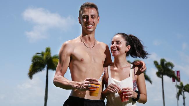 The weather in Cairns has become hot and will only get hotter, with no cool reprieve forecast. Cairns work colleagues Ryan Sherwood and Innes Cortez enjoy the sunny day with a fresh juice and some fruit salad on the Cairns Esplanade. Picture: Brendan Radke