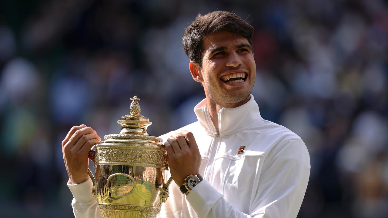 Carlos Alcaraz of Spain celebrates with the trophy after defeating Novak Djokovic of Serbia in the Gentlemen's Singles Final during day fourteen of The Championships Wimbledon 2024. (Photo by Julian Finney/Getty Images)