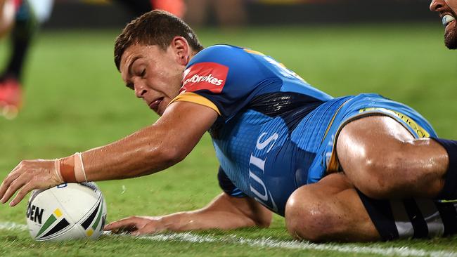 Titans player Ashley Taylor crosses over to score during the Round 3 NRL match between the Gold Coast Titans and the West Tigers at CBUS Stadium on the Gold Coast, Saturday, March 19, 2016. (AAP Image/Dave Hunt) NO ARCHIVING, EDITORIAL USE ONLY