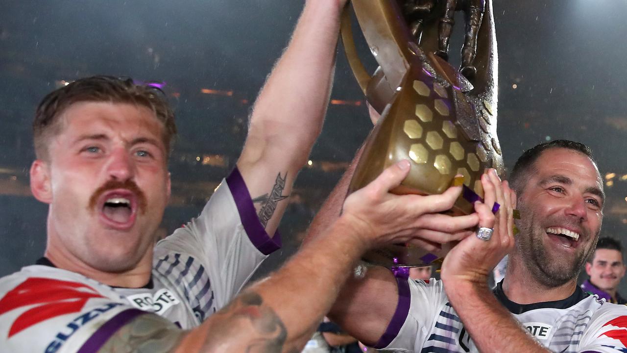 SYDNEY, AUSTRALIA - OCTOBER 25: Cameron Munster of the Storm and Cameron Smith of the Storm pose with the Premiership trophy after winning the 2020 NRL Grand Final match between the Penrith Panthers and the Melbourne Storm at ANZ Stadium on October 25, 2020 in Sydney, Australia. (Photo by Cameron Spencer/Getty Images)