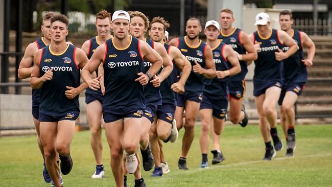 Brodie Smith and Riley Knight lead a run around the boundary at Thebarton Oval on Monday. Picture: Mike Burton (AAP).