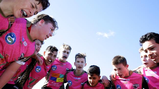 The Rouse Hill Rhinos under 14 team belt out their winning song during the pink day. Pictures: Peter Kelly