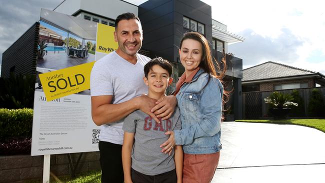 Muhummad, Tenille and son Jacob Akkouche outside their southwest Sydney family home, which sold at a weekend auction for $100,000 above reserve. Picture: Jane Dempster