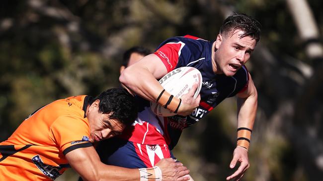 Runaway Bay Seagulls' Luke Burton runs at the Southport Tigers defence during their Rugby League match at Bycroft oval on the Gold Coast. Photograph : Jason O'Brien