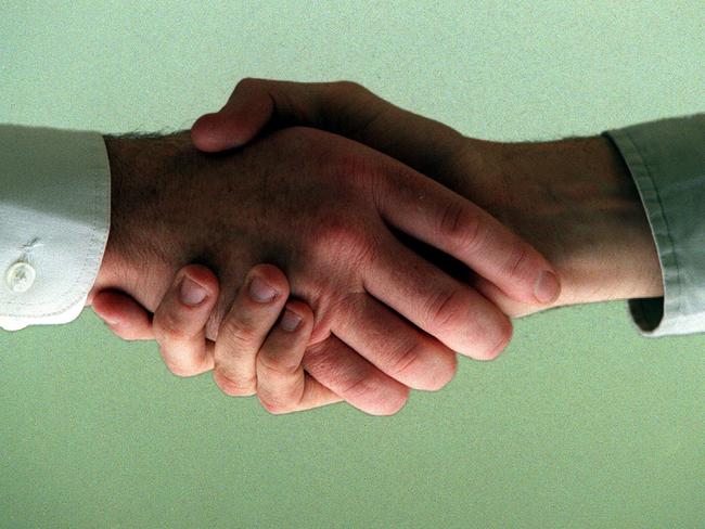 Generic photo of two men shaking hands 09 Jul 2000.