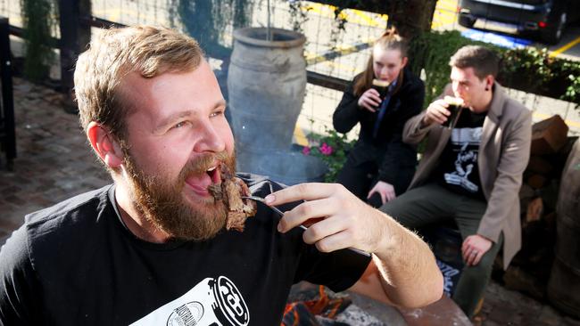 David Ward, Jordan Richards and Paul Fear tuck into beef brisket and stouts at the brewery. Pictures: Angelo Velardo