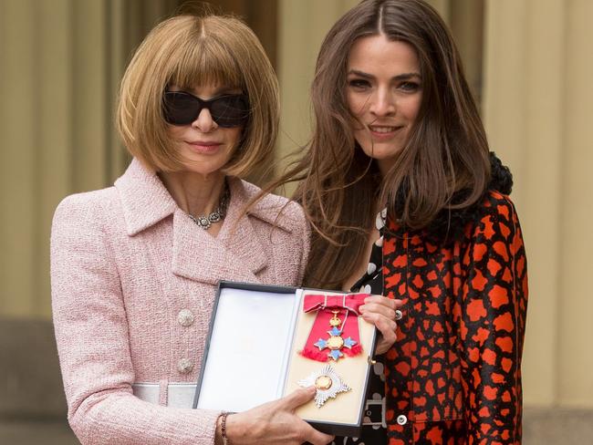 Britain's Anna Wintour, editor of US Vogue flanked by her daughter Bee Schaffer, poses with her medal after being appointed Dame Commander of the Most Excellent Order of the British Empire (DBE) for services to fashion and journalism. Picture: AFP