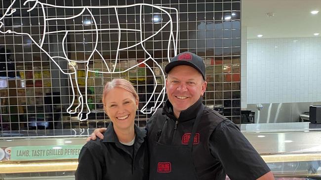 Owners of Stirling Variety Meats Chris and Giselle Pfitzner outside their store in Stirling Village shopping centre before it was completely destroyed yesterday. Photo: Instagram