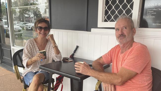 Penny and John Madison of Paradise Point enjoy some coffee while they wait for Cyclone Alfred on Friday morning. Photo: Kathleen Skene