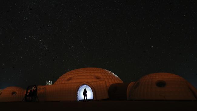 A Mars simulation mission participant wearing a spacesuit standing in the doorway of a simulation habitat in Oman’s Dhofar desert. Picture: Karim Sahib