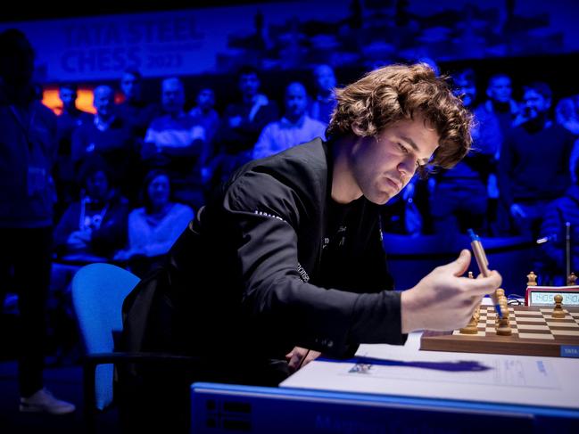 (FILES) Norway's Magnus Carlsen competes during the fifth round of the Tata Steel Masters chess tournament in Amsterdam on January 19, 2023. Norwegian multiple world chess champion Magnus Carlsen and American Hans Niemann, accused of cheating at an event last year, have buried the hatchet and are ready to face off again, online platform Chess.com said on August 28, 2023. "Since June, both sides have negotiated privately in a good-faith effort to resolve their issues and allow the chess world to move forward without further litigation," Chess.com said in a statement. "We are happy to share that all sides have reached an agreement." The fallout between the pair dates back to September when 20-year-old Niemann defeated Carlsen at the Sinquefield Cup, an annual match-up held in St. Louis, Missouri. (Photo by Koen van Weel / ANP / AFP) / Netherlands OUT