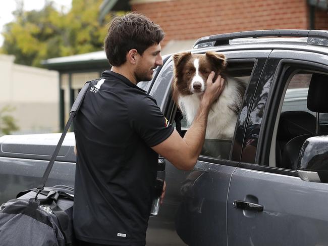 Sam Mayes says a big goodbye to his dog Alfie, before heading to the AFL’s hub on the Gold Coast. Picture: Sarah Reed