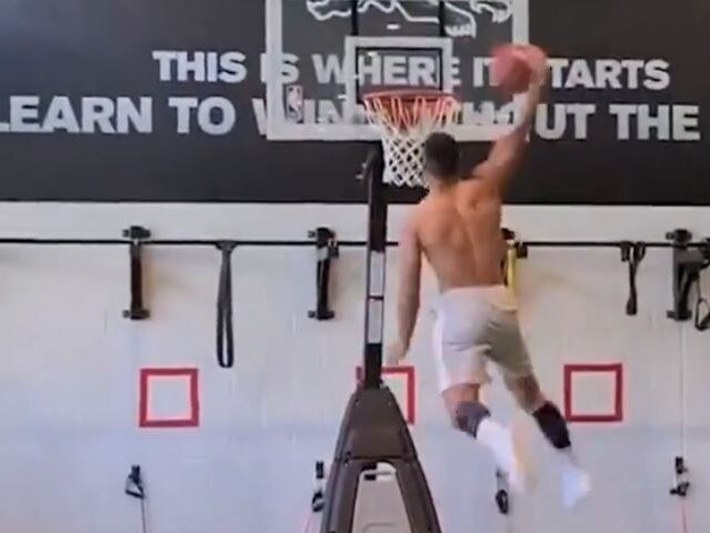 A talented baskballer during his school days, Crichton lays down a big windmill dunk.