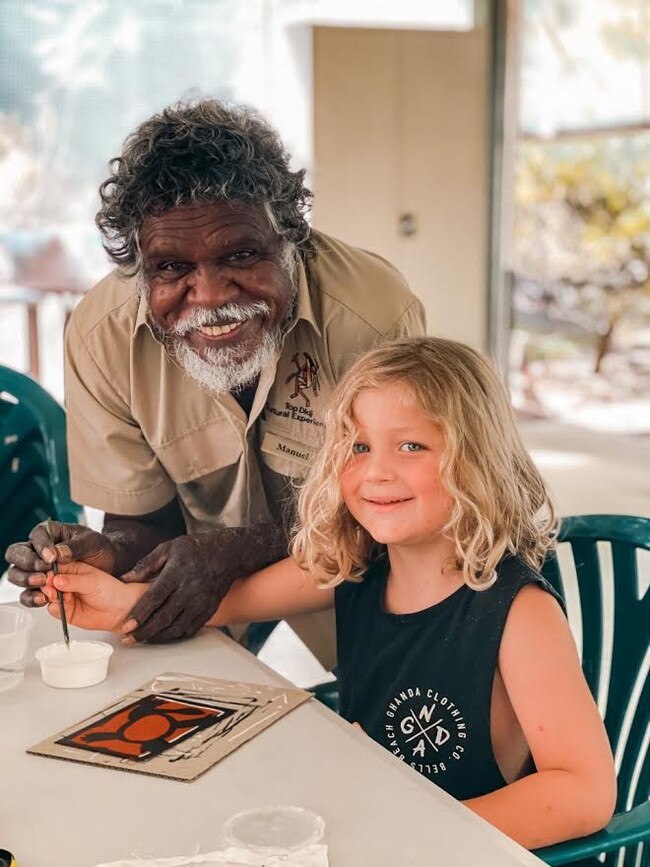 Top End Aboriginal artist Manuel Pamkal from Top Didj Cultural Experience &amp; Art Gallery Katherine in the Northern Territory shows this young boy the technique of Rarrk painting (Cross Hatch). Picture: @morgansfootsteps_