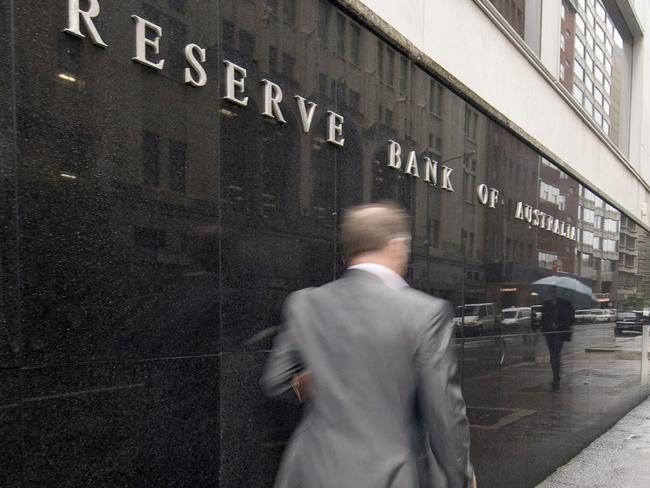 A pedestrian walks past the Reserve Bank of Australia headquarters in Sydney, Australia, on Tuesday, May 18, 2010. Australia's monetary policy is "well placed" after six increases in the benchmark interest rate in seven meetings, the central bank said as it weighs Europe's debt crisis against inflation risks. Photographer: Gillianne Tedder/Bloomberg