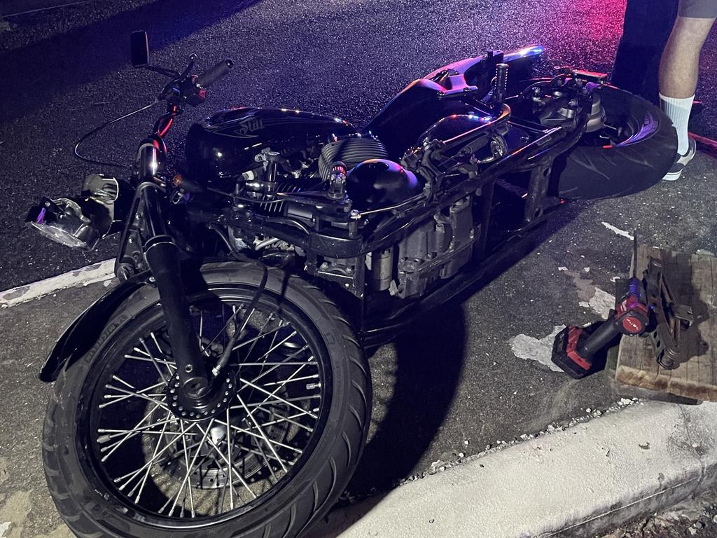 Bystanders quickly acted to move the motorbike, clearing space for the rescue. Picture: Paul Brescia